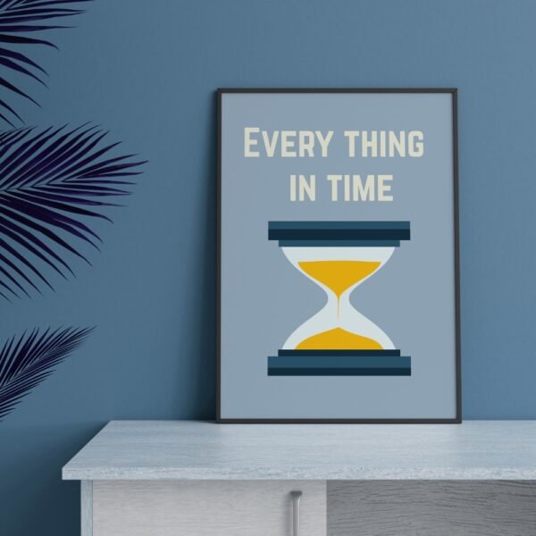 Motivational wall frame with an hourglass and the text 'EVERY THING IN TIME' on a teal wall above a wooden cabinet. Best wall frames for a home, wall frames with economic prices, wall frames for a luxury house, motivational wall frames and images, self-healing wall frames and images.